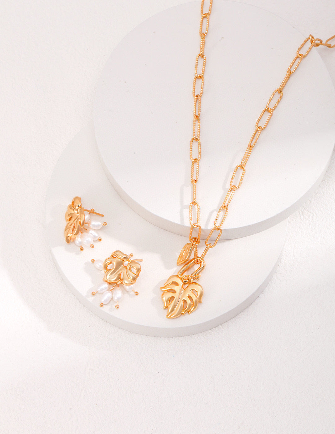 Gold monstera necklace and earrings